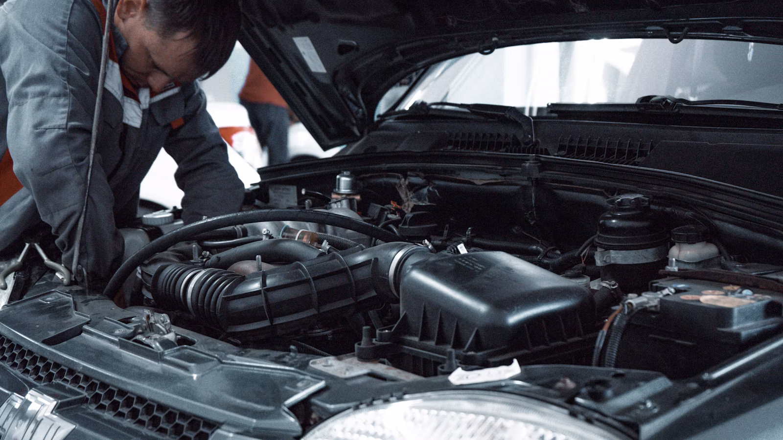 Mechanic inspecting car engine